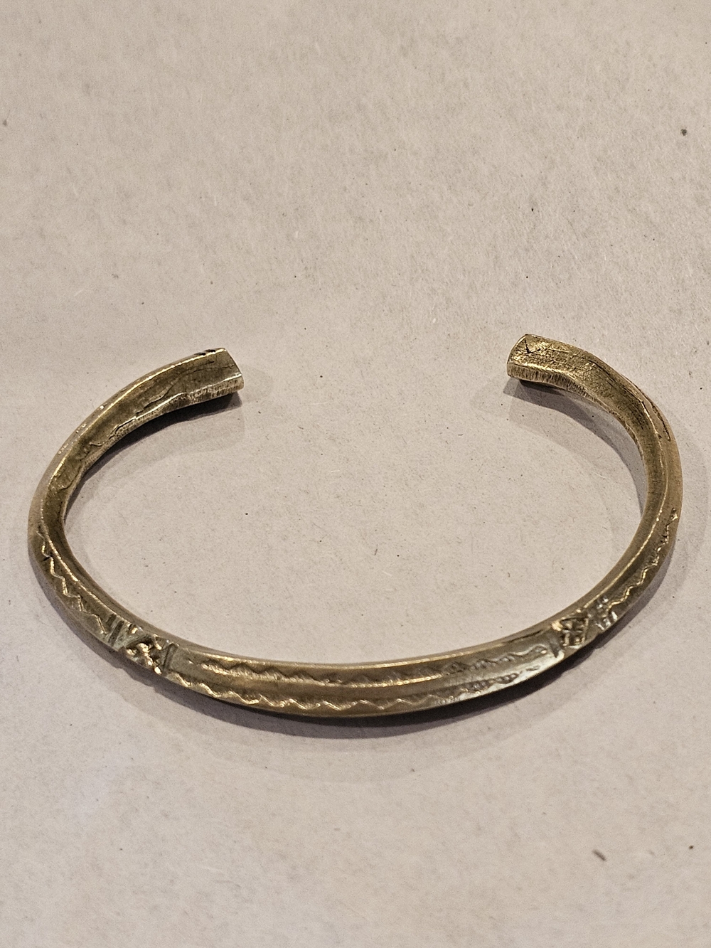 Hand-forged vintage brass cuff bracelet featuring artisan-stamped geometric